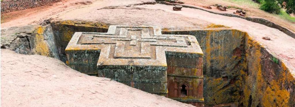 Ethiopia Tours - Lalibela Church from above showing the cross shaped building carved into the rocks.