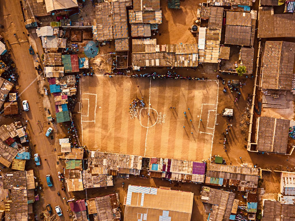 West Africa Small Group Tour - 14 Day Ghana Togo Benin Tour 2 Aerial shot of an urban football field surrounded by dense housing in Accra, Ghana.