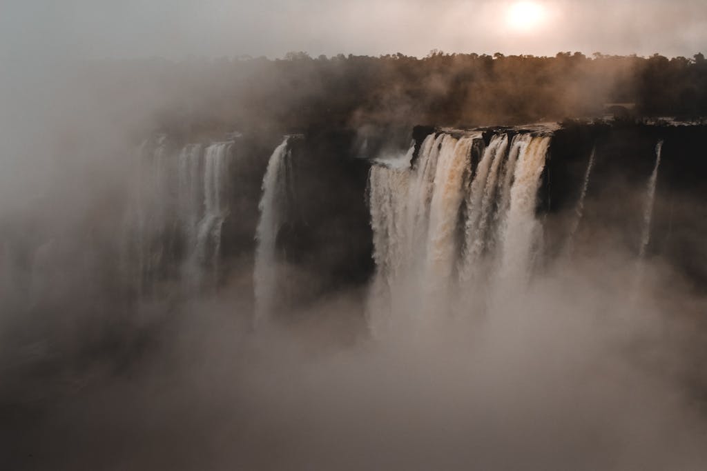 15 Day Botswana and Zimbabwe Small Group Tour 2 A stunning view of a grand waterfall enveloped by mist, showcasing nature's beauty.