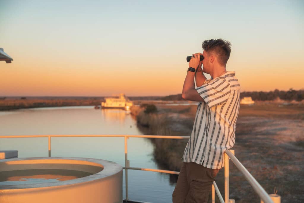 Chobe Princess Guest looking through binoculars