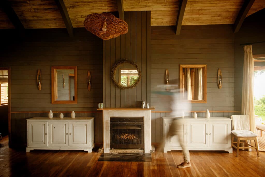 A waiter walks past the warming fire in the dining area